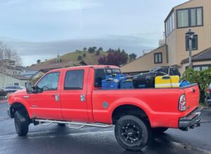 Big red truck carrying luggage to the airport in San Francisco.