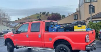 Big red truck carrying luggage to the airport in San Francisco.